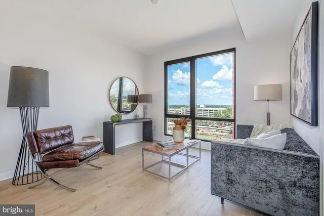 a bedroom with a large bed and a large window with the outer view