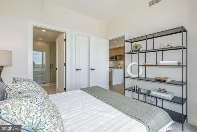 a bathroom with a toilet a sink a mirror and a shower