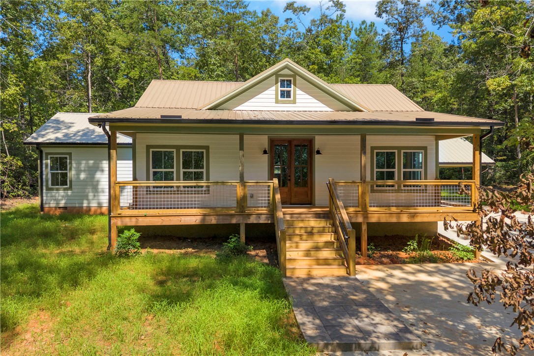 659 White Oak Farms Road Tamassee, SC 29686 - Photo 1 of 50 An inviting front porch with wooden steps leads into this charming country home.