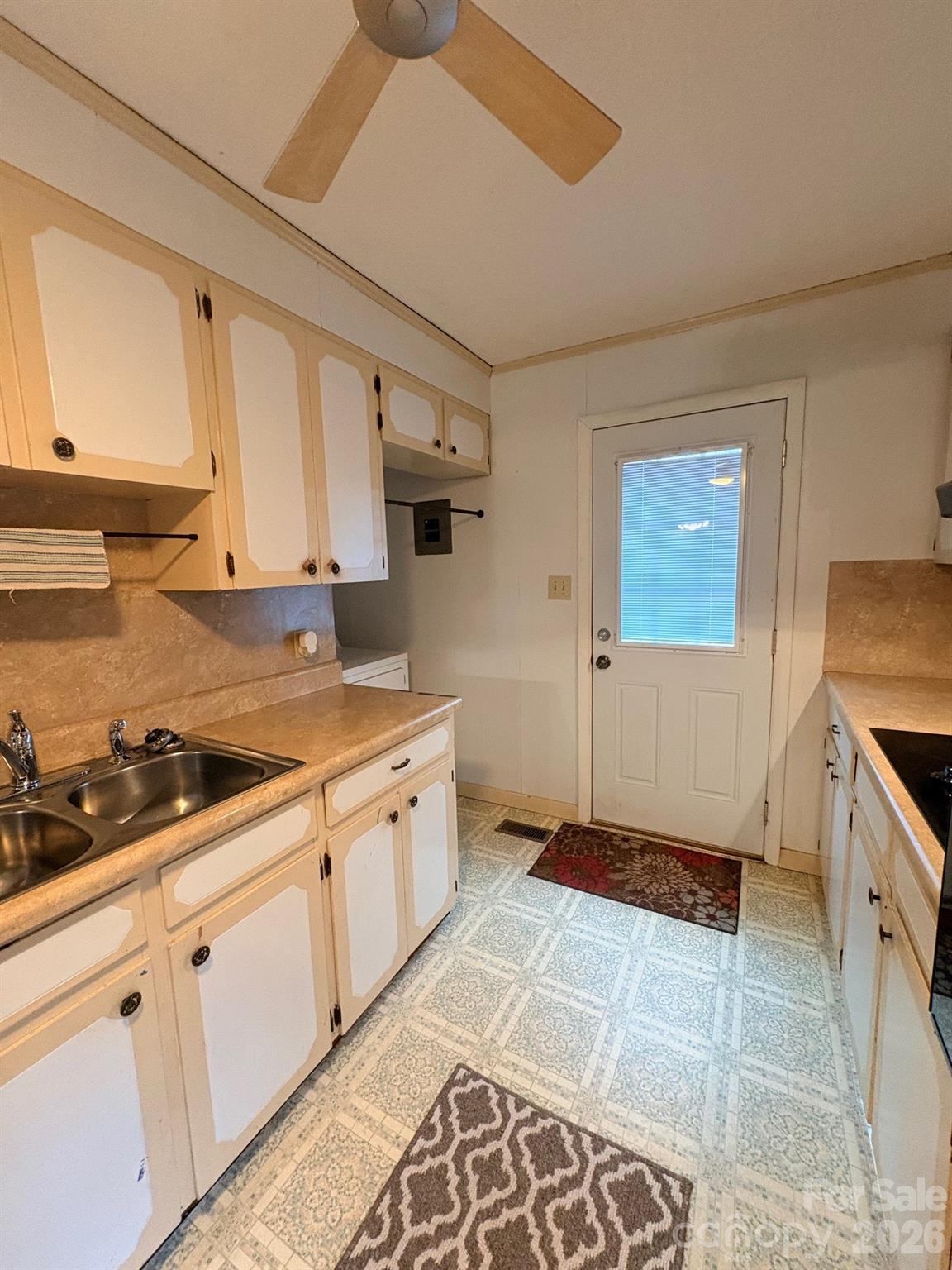 3955 Tower Road Maiden, NC 28650 - Photo 8 of 45 a kitchen with granite countertop a sink a stove a microwave and cabinets