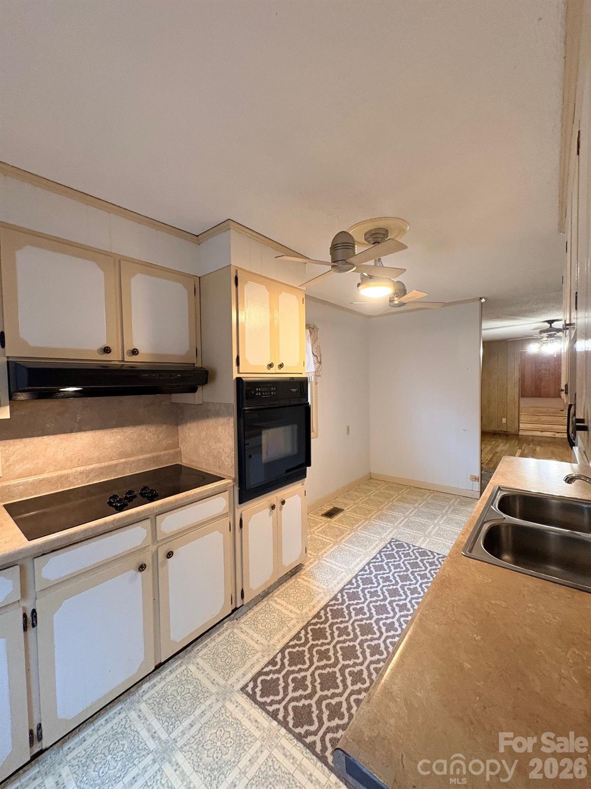 3955 Tower Road Maiden, NC 28650 - Photo 9 of 45 a kitchen with granite countertop a sink and a stove top oven