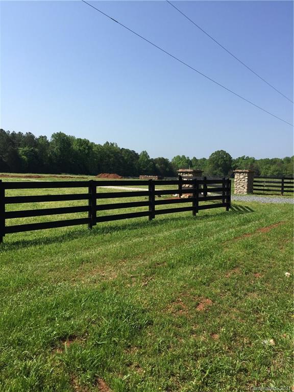 1916 State Rd S-46-168, Unit 2 York, SC 29745 - Photo 2 of 5 a view of a green field with wooden fence