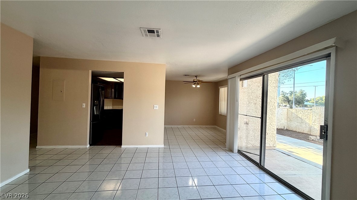 6250 West Flamingo Road, Unit 4 Las Vegas, NV 89103 - Photo 9 of 45 This living space offers an open layout, connecting to the kitchen, with tiled flooring and a sliding glass door.