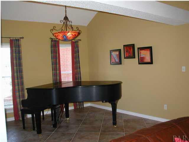 2583 Valley Road Navarre, FL 32566 - Photo 9 of 12 In what used to be used as the fomal dining room, is now being utilized as a music room for the baby-grand.
