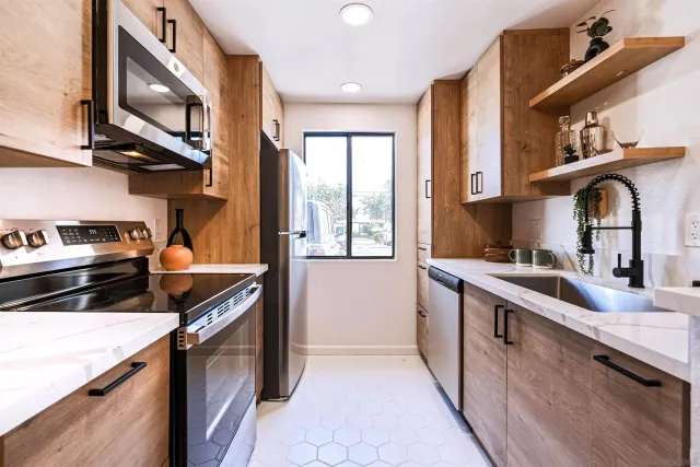 a kitchen with stainless steel appliances granite countertop a stove and a sink