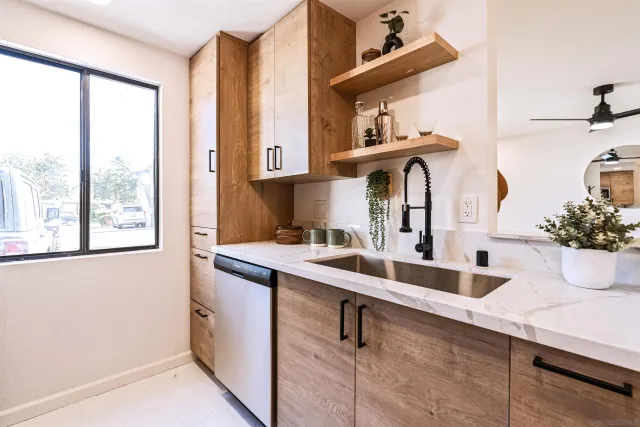 a kitchen with stainless steel appliances a sink and a window