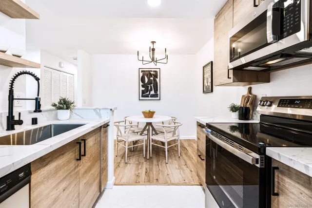 a kitchen with stainless steel appliances kitchen island granite countertop a sink and cabinets