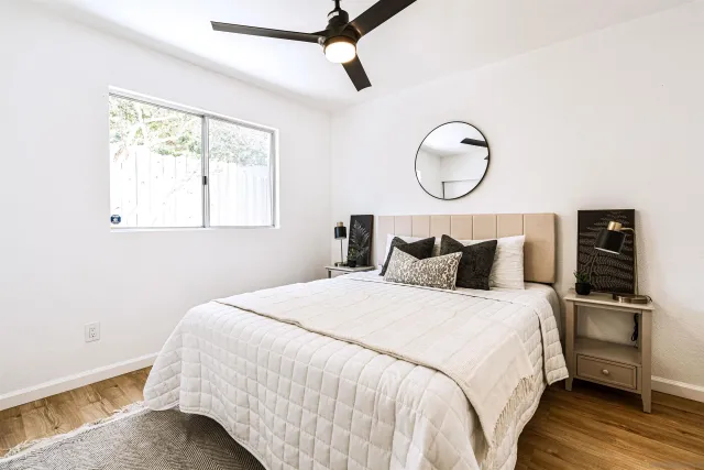 a bedroom with bed and a window