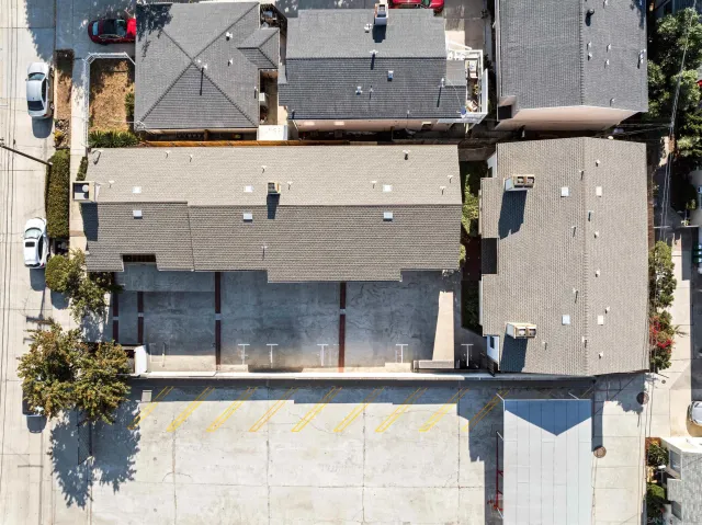 an aerial view of residential houses with outdoor space