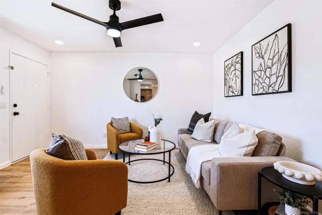 a living room with furniture and a fan