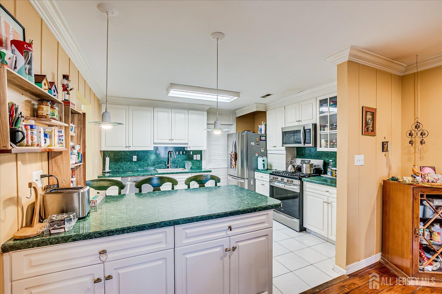 118 Coppertree Court Edison, NJ 08820 - Photo 19 of 58 a kitchen with stainless steel appliances granite countertop a sink a stove and a refrigerator