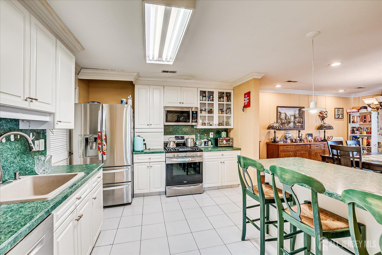 118 Coppertree Court Edison, NJ 08820 - Photo 20 of 58 a kitchen with stainless steel appliances granite countertop a stove top oven a sink dishwasher and white cabinets with wooden floor