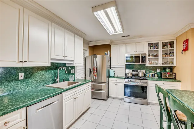 a view of a dining room with furniture a chandelier and wooden floor