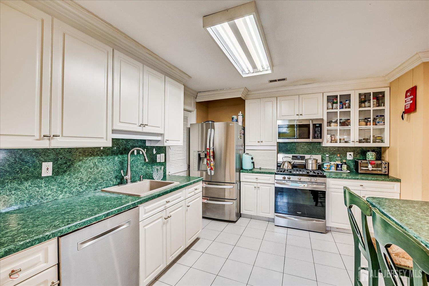 118 Coppertree Court Edison, NJ 08820 - Photo 21 of 58 a kitchen with stainless steel appliances granite countertop a stove and cabinets