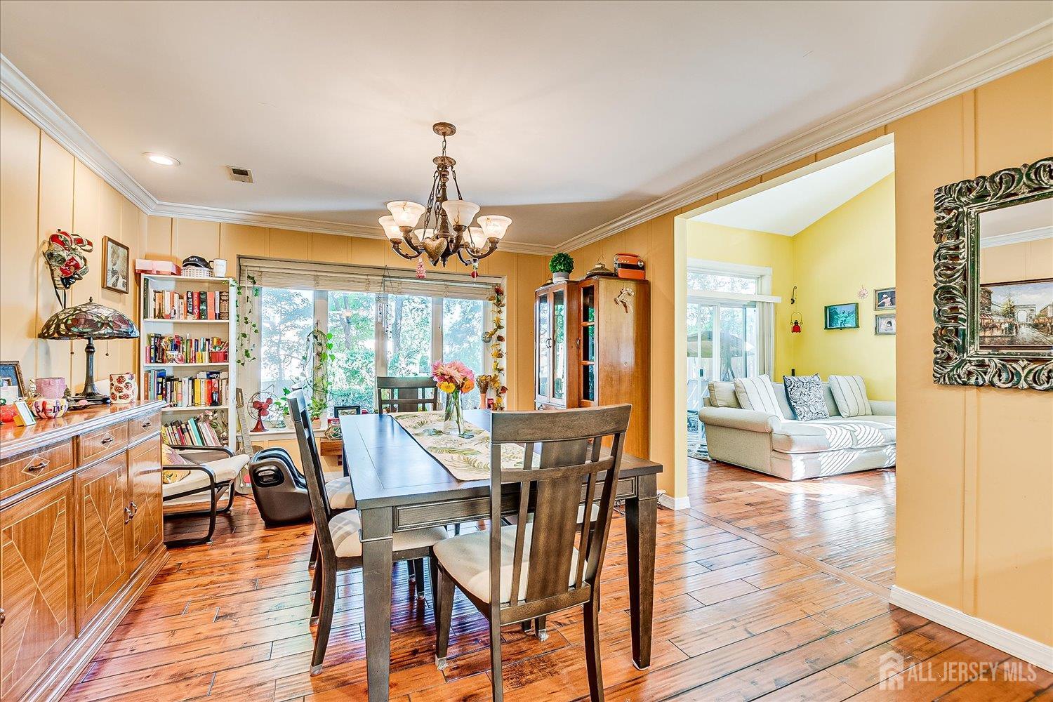118 Coppertree Court Edison, NJ 08820 - Photo 23 of 58 a view of a dining room with furniture wooden floor and chandelier