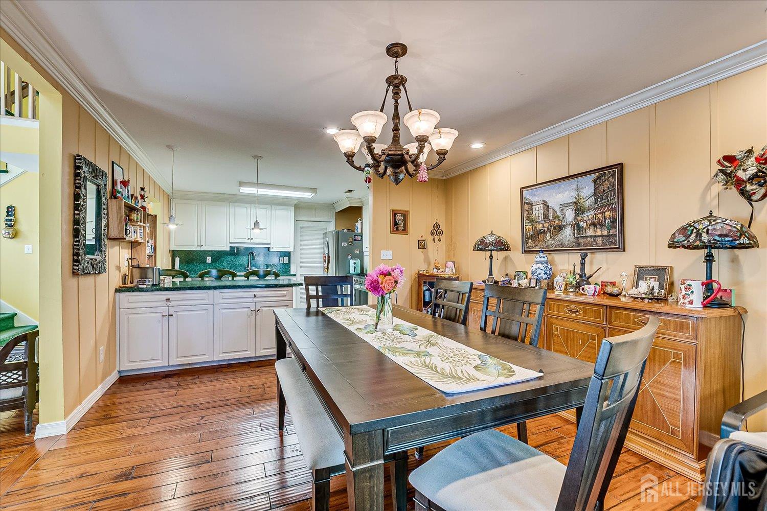 118 Coppertree Court Edison, NJ 08820 - Photo 25 of 58 a view of a dining room with furniture a chandelier and wooden floor