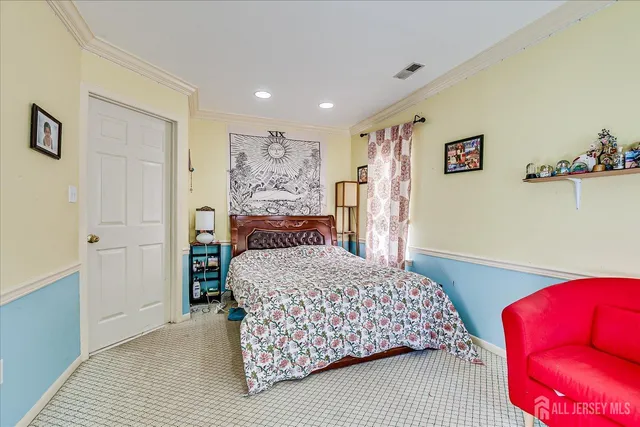 a bedroom with a bed and a television