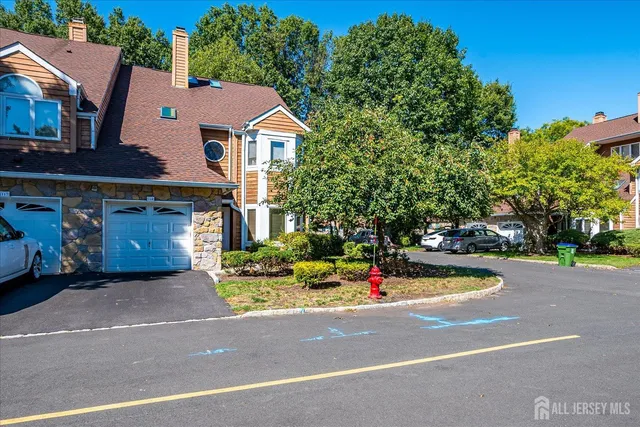 a front view of a house with a yard and potted plants