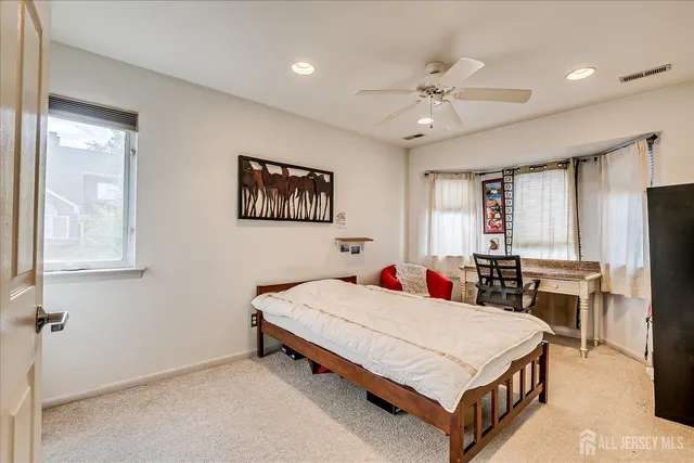 a bedroom with a bed couch and a window