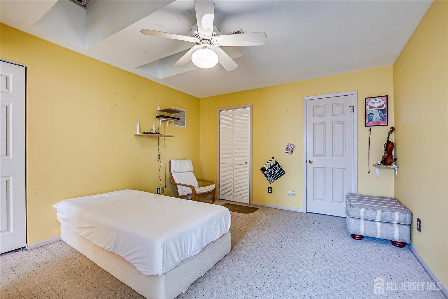 118 Coppertree Court Edison, NJ 08820 - Photo 40 of 58 a bedroom with a bed and a chandelier