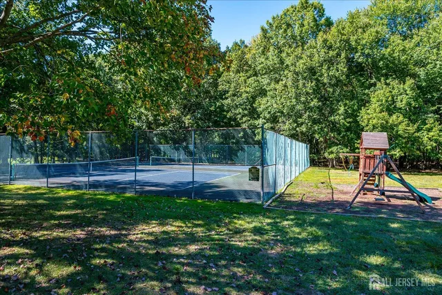 an aerial view of a house with a yard and trees