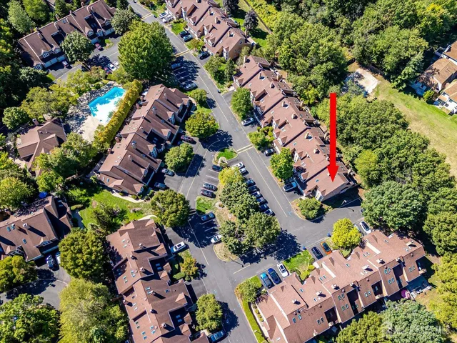 a front view of a house with a tree