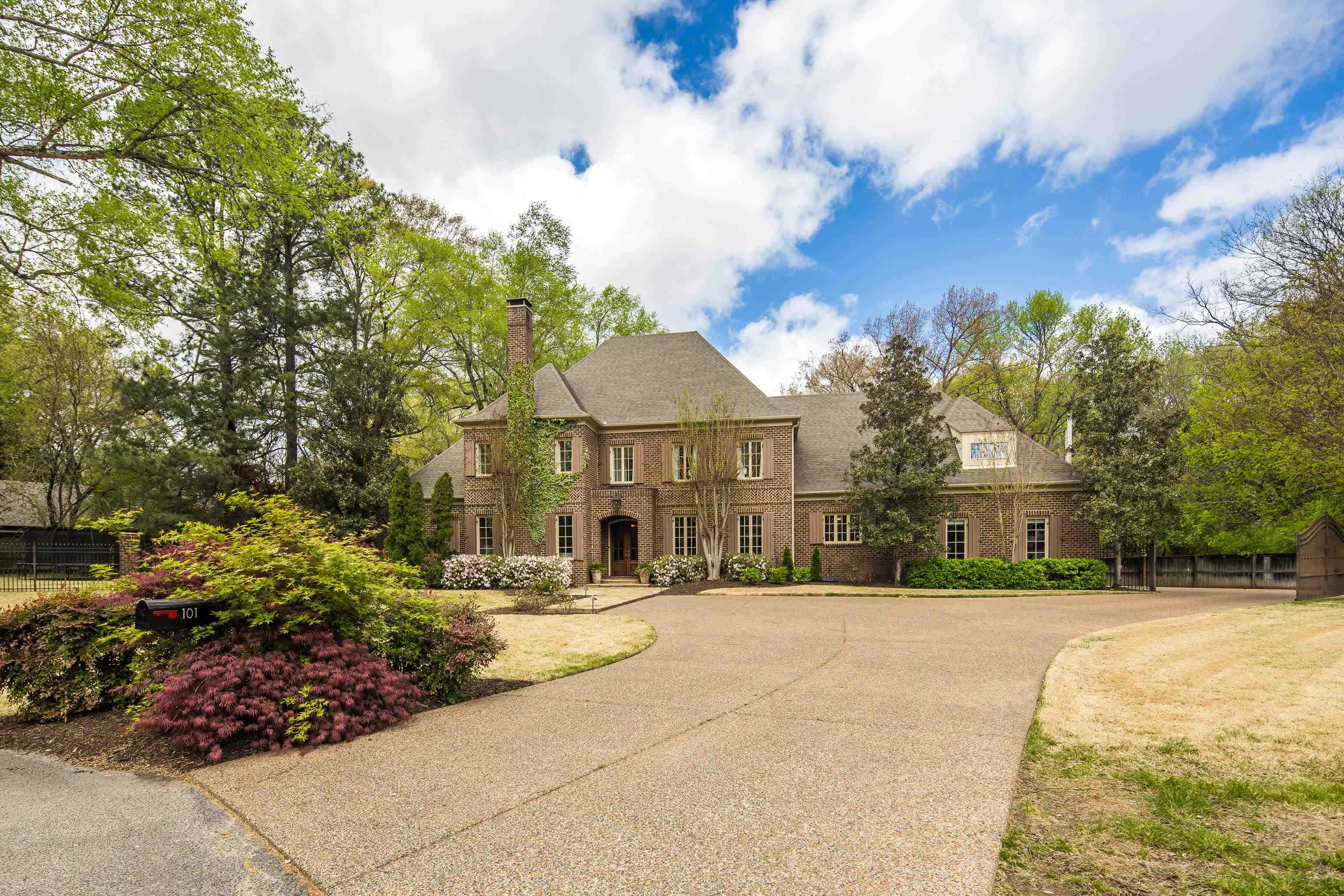 101 North Grove Park Road Memphis, TN 38117 - Photo 1 of 40 Georgian-style home featuring a chimney, brick siding, and concrete driveway