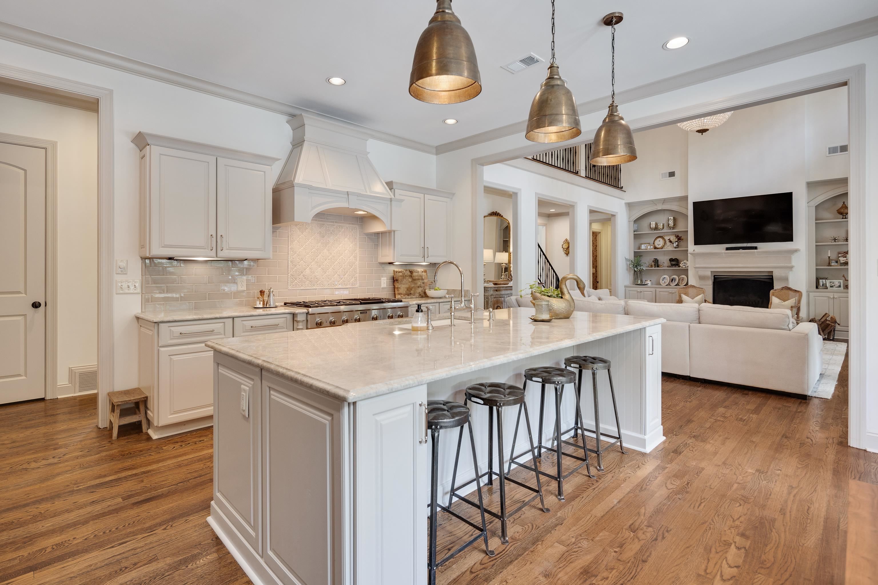 101 North Grove Park Road Memphis, TN 38117 - Photo 40 of 40 Kitchen featuring a breakfast bar area, a large island, light stone counters, open floor plan, and built in features