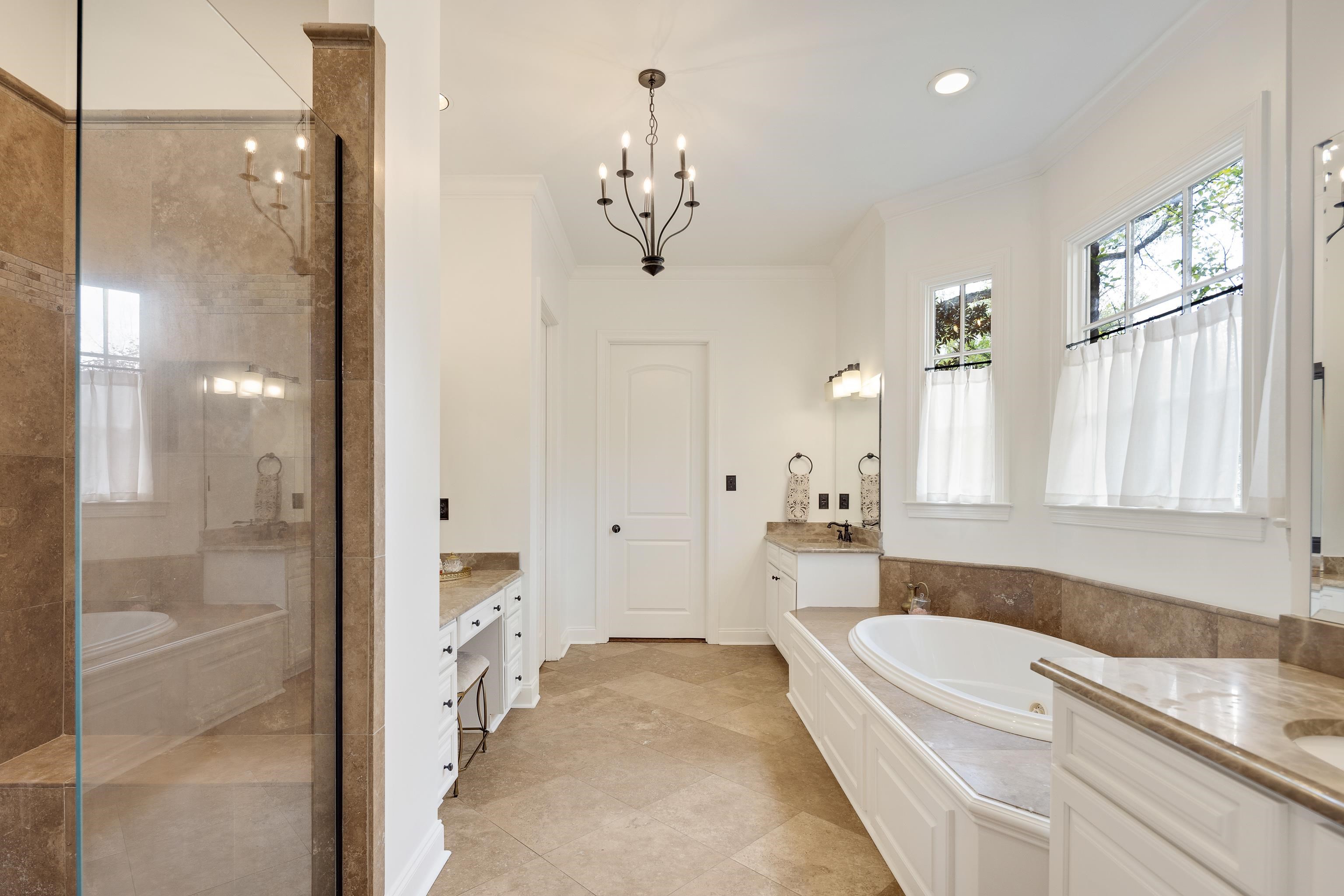 101 North Grove Park Road Memphis, TN 38117 - Photo 17 of 40 Bathroom with two vanities, ornamental molding, a shower stall, a garden tub, and hanging lights