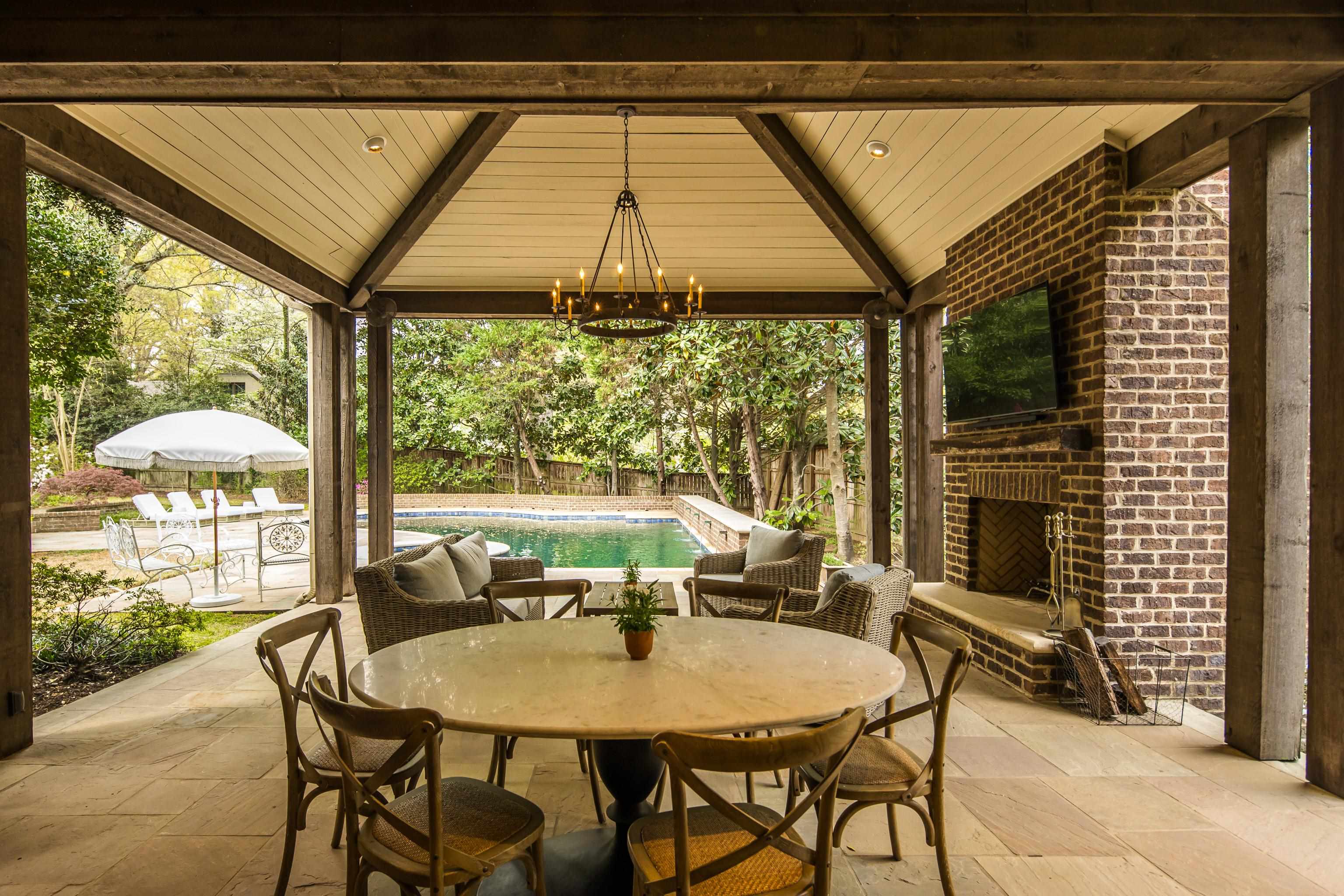 101 North Grove Park Road Memphis, TN 38117 - Photo 36 of 40 Fenced backyard featuring an outdoor brick fireplace, outdoor dining area, and a patio area