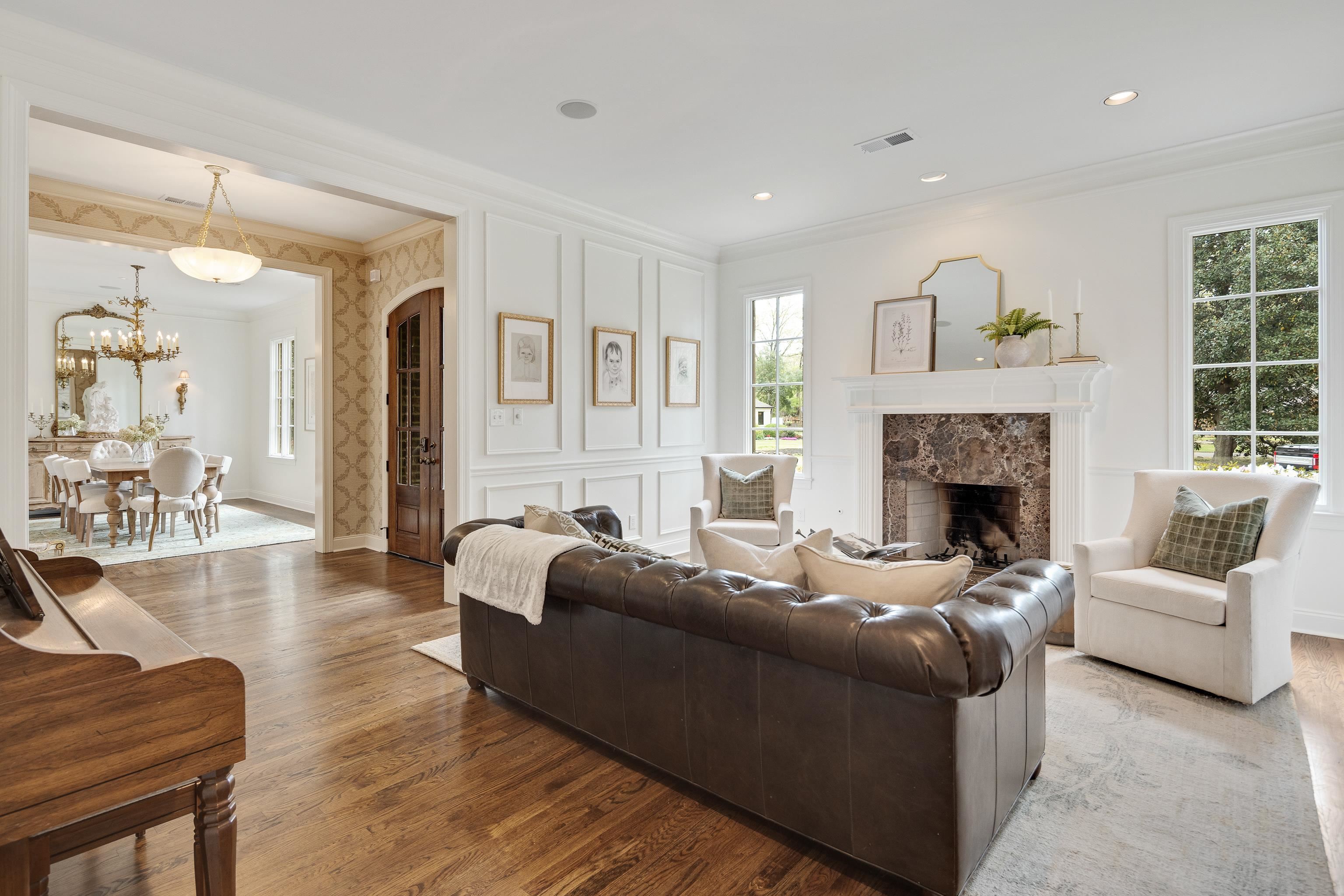 101 North Grove Park Road Memphis, TN 38117 - Photo 7 of 40 Living room with arched walkways, wood finished floors, crown molding, a premium fireplace, and suspended lighting