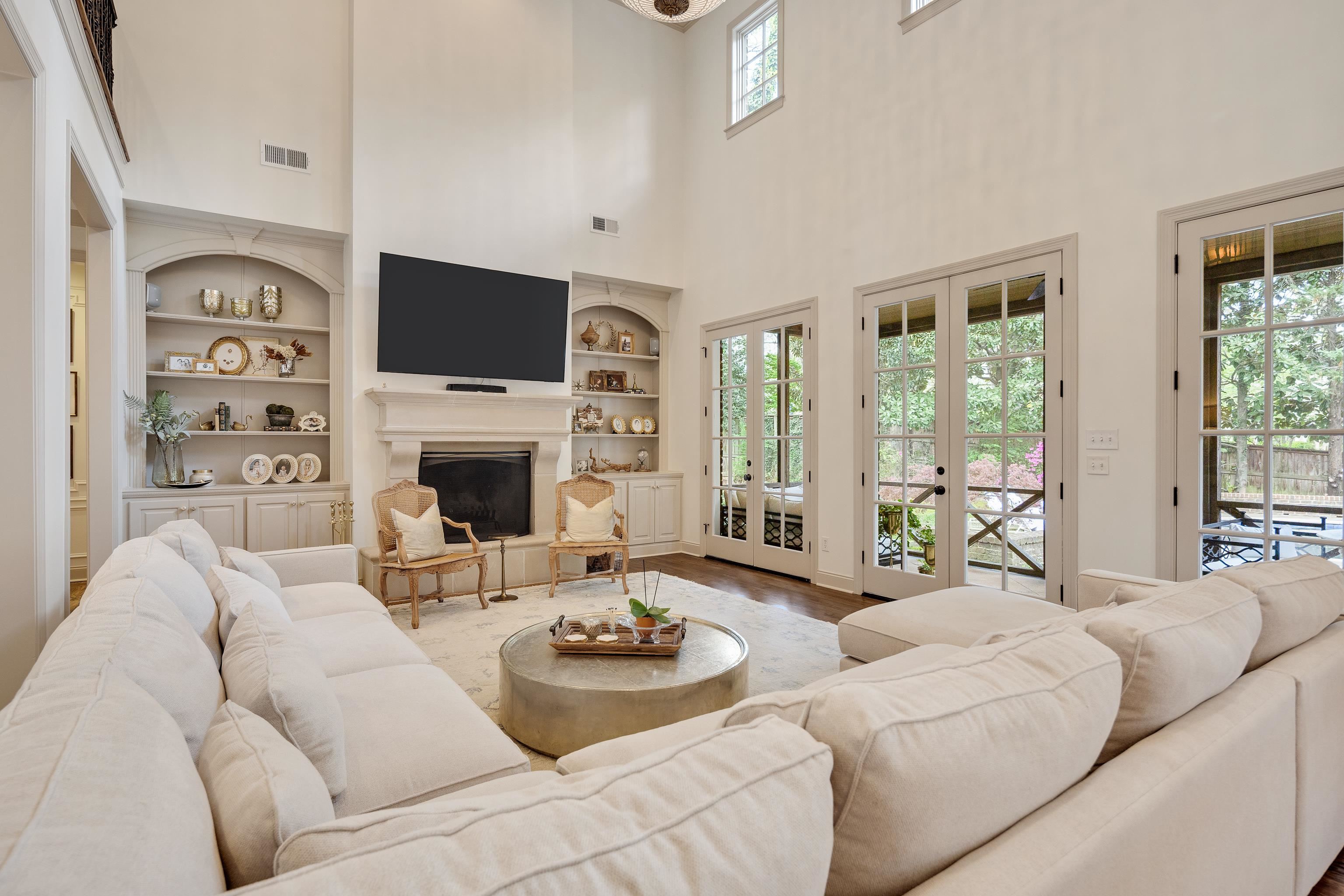 101 North Grove Park Road Memphis, TN 38117 - Photo 10 of 40 Living room featuring a glass covered fireplace, wood finished floors, a high ceiling, and built in features