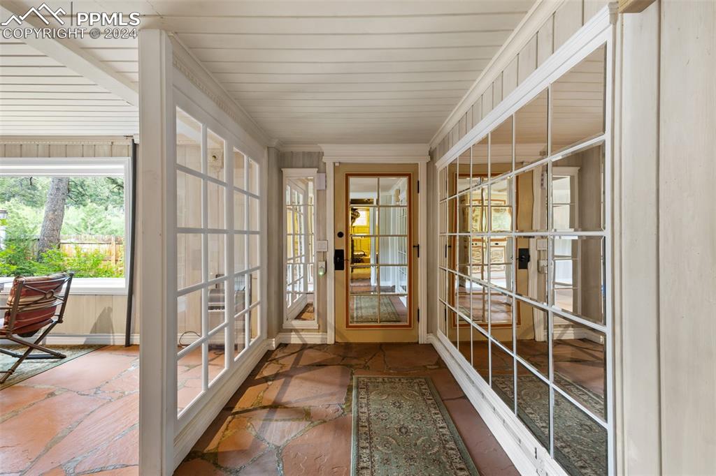 7955 Highway 24 Cascade, CO 80809 - Photo 19 of 44 a view of a porch with wooden floor and windows