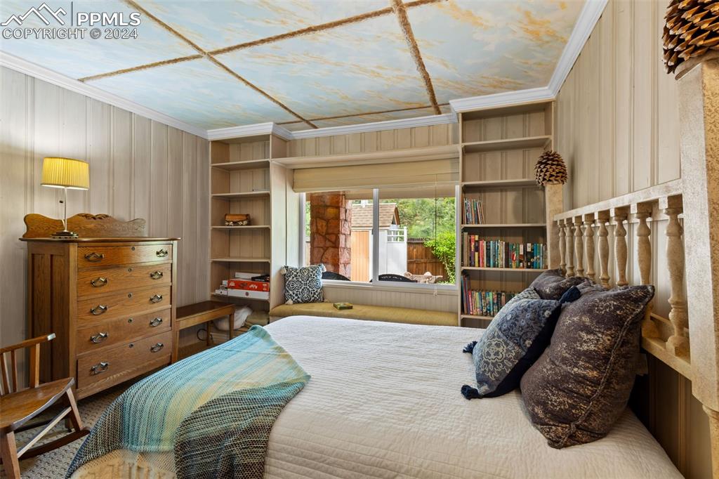 7955 Highway 24 Cascade, CO 80809 - Photo 20 of 44 a bed room with a bed and a book shelf