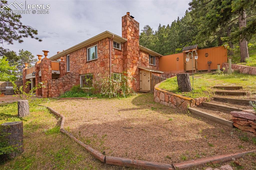 7955 Highway 24 Cascade, CO 80809 - Photo 29 of 44 a view of a house with a yard
