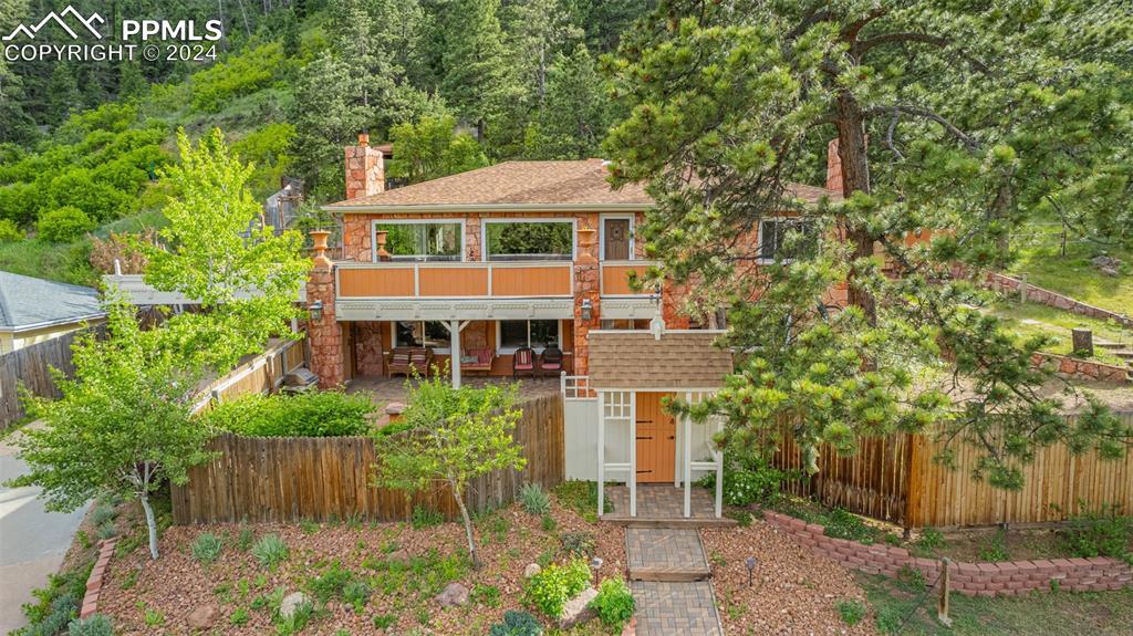 7955 Highway 24 Cascade, CO 80809 - Photo 40 of 44 a front view of a house with a yard