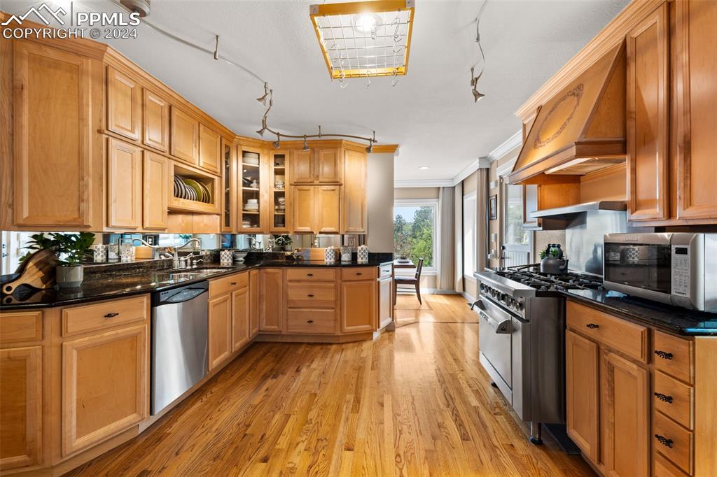 7955 Highway 24 Cascade, CO 80809 - Photo 5 of 44 a kitchen with stainless steel appliances granite countertop a stove a sink dishwasher and a refrigerator