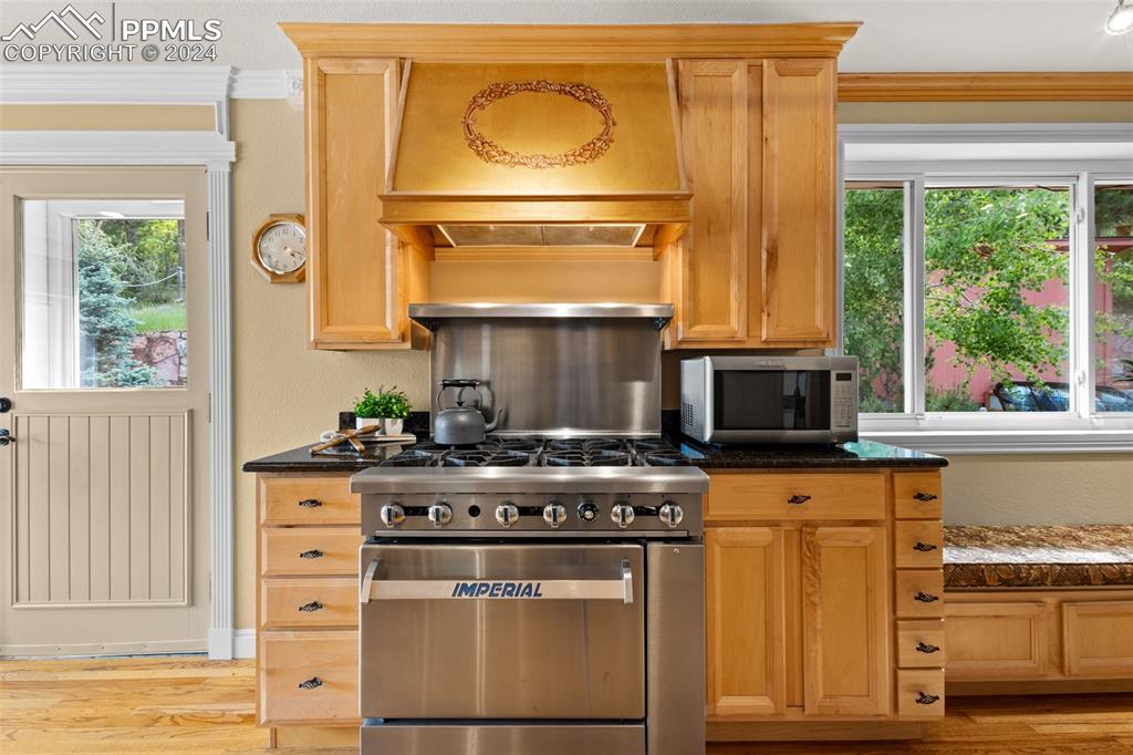 7955 Highway 24 Cascade, CO 80809 - Photo 7 of 44 a kitchen with granite countertop a stove a sink and a microwave