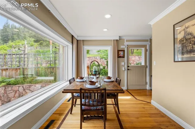 a view of a dining room with furniture window and wooden floor