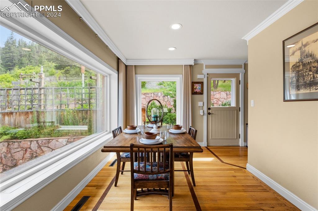 7955 Highway 24 Cascade, CO 80809 - Photo 8 of 44 a view of a dining room with furniture window and wooden floor