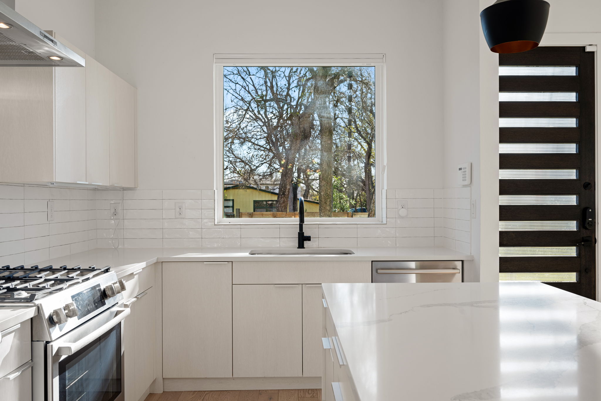 910 Nalide Street, Unit B Austin, TX 78745 - Photo 11 of 38 a kitchen with a sink a stove and a refrigerator
