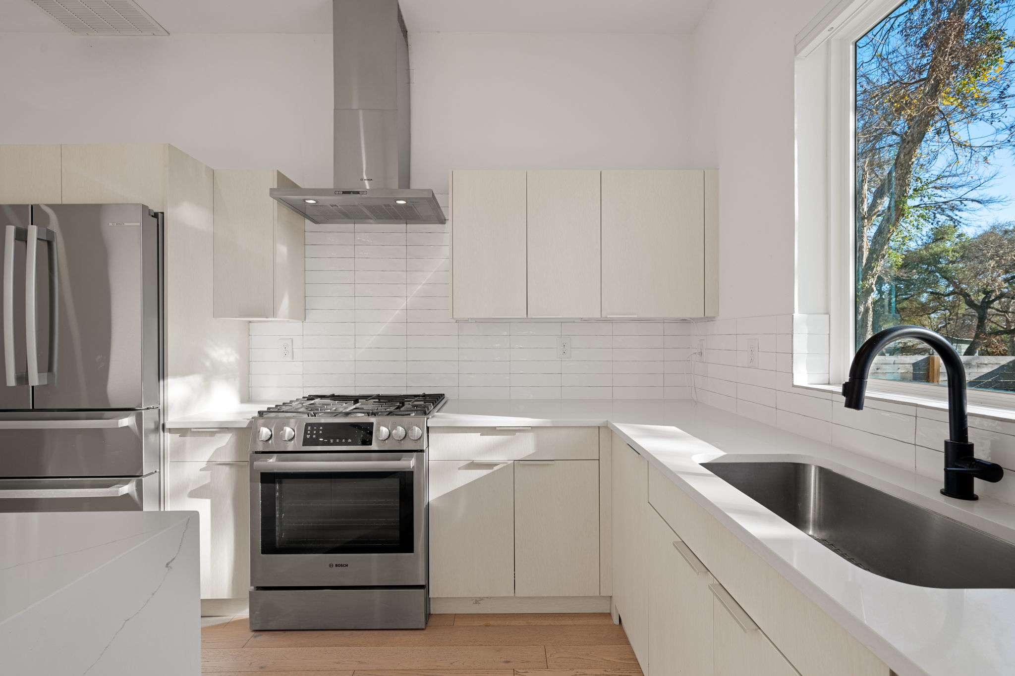 910 Nalide Street, Unit B Austin, TX 78745 - Photo 14 of 38 a kitchen with stainless steel appliances granite countertop a stove a sink and a refrigerator