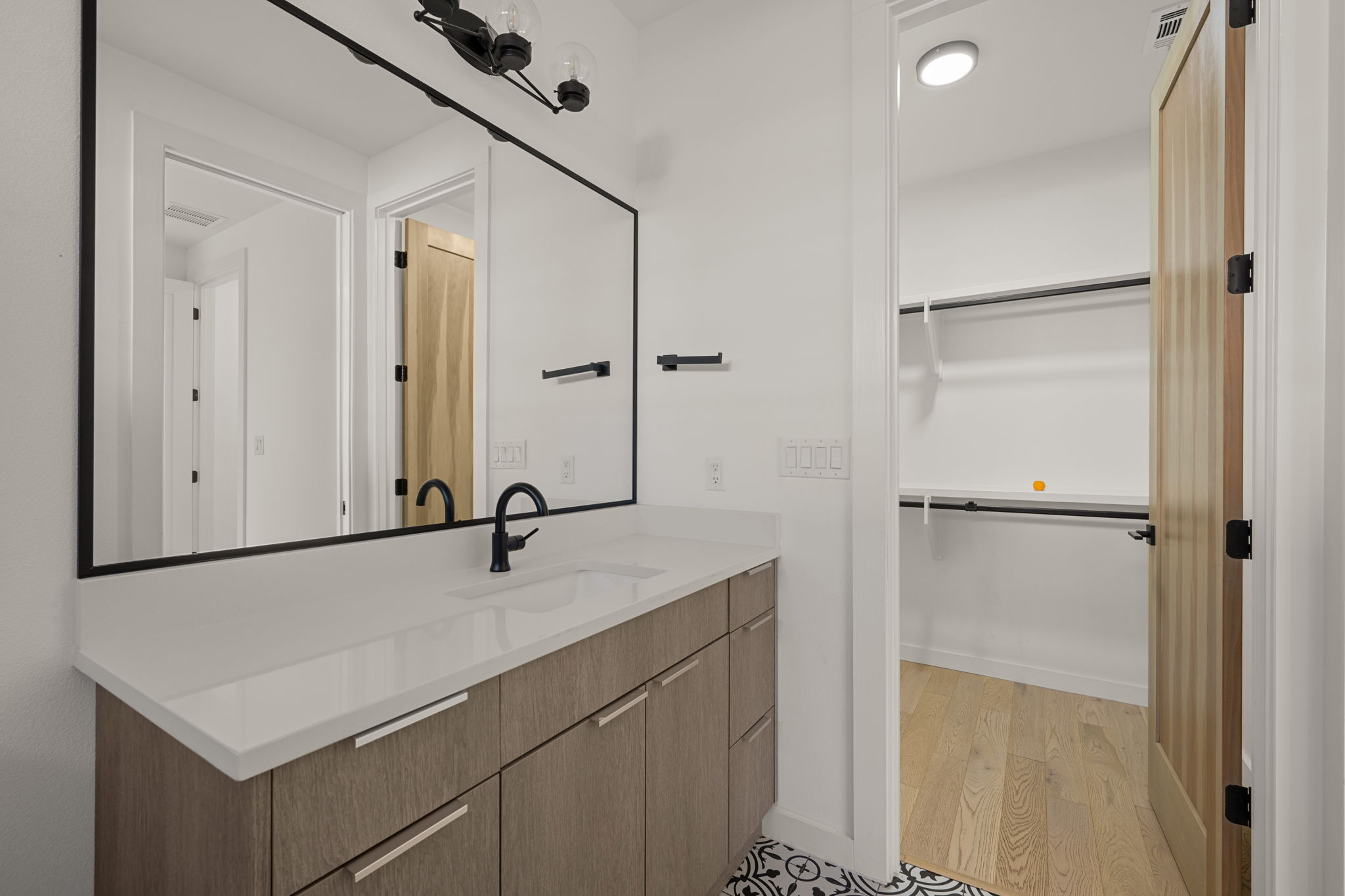 910 Nalide Street, Unit B Austin, TX 78745 - Photo 31 of 38 a bathroom with a sink and mirror