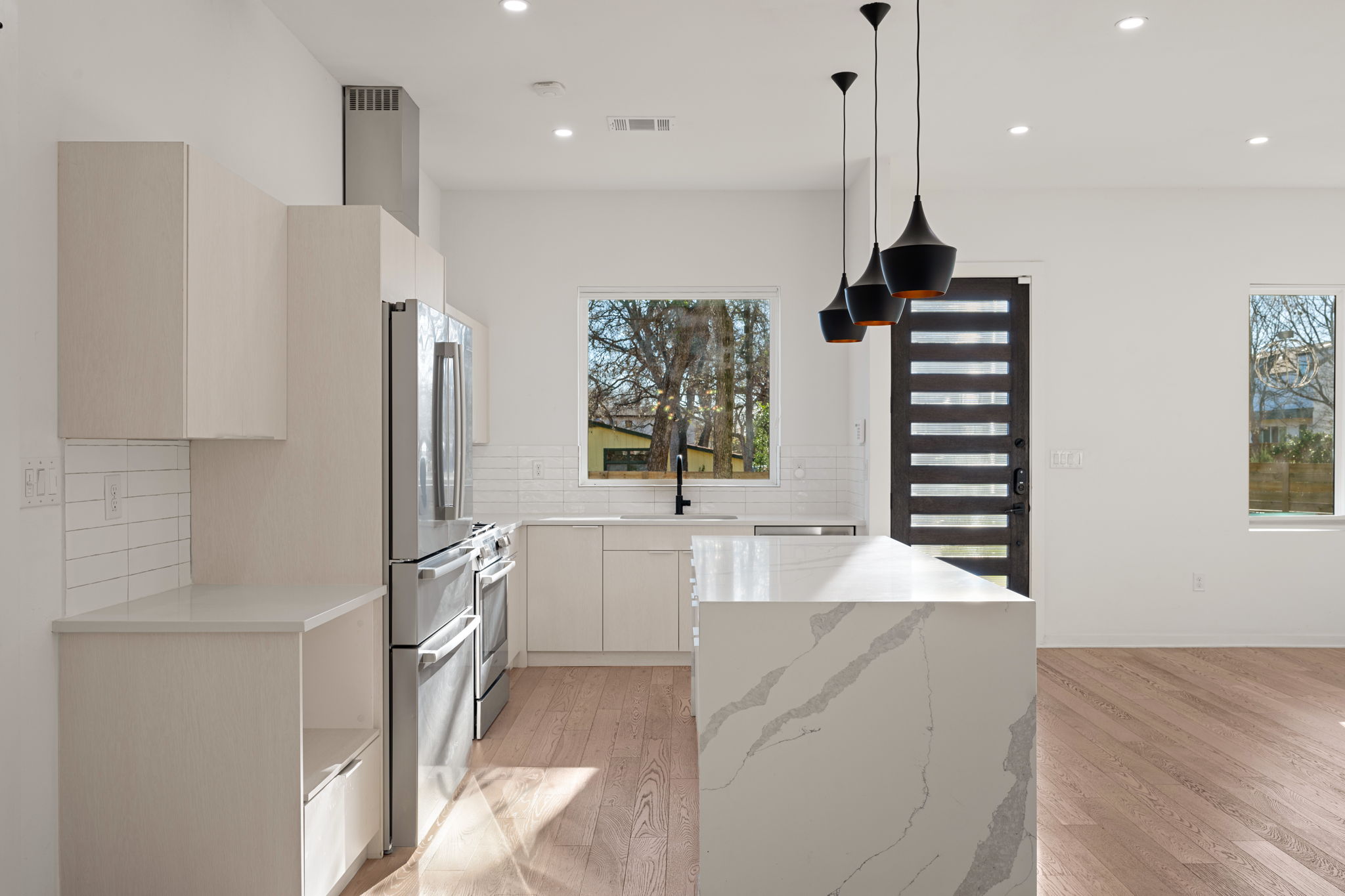 910 Nalide Street, Unit B Austin, TX 78745 - Photo 10 of 38 a kitchen with stainless steel appliances a refrigerator and a sink
