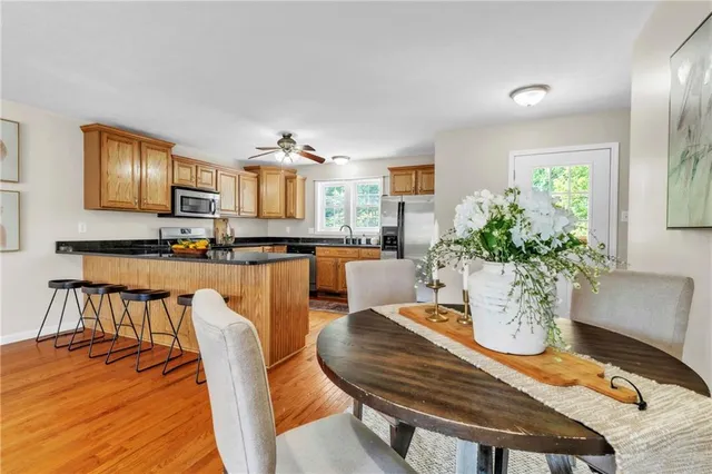 a dining room with furniture and wooden floor