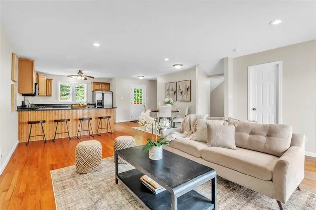 a living room with furniture and kitchen view