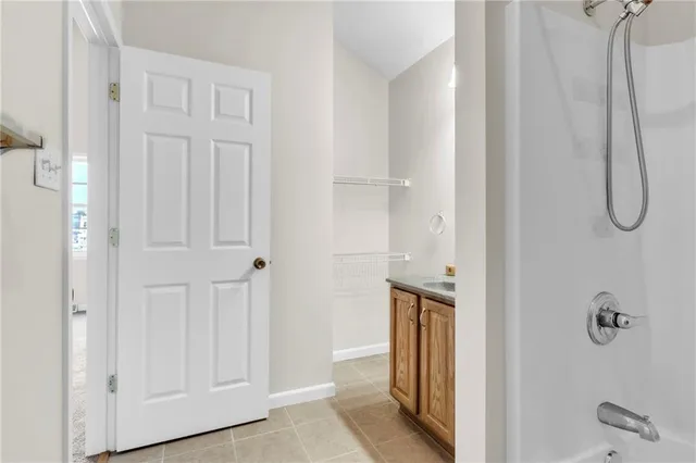 a bathroom with a granite countertop shower