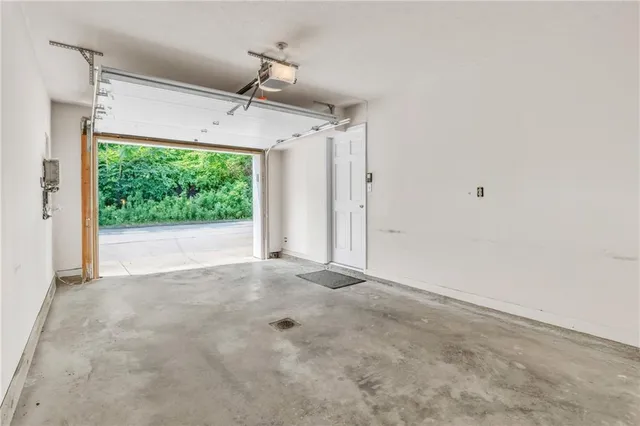 a view of a big room with wooden floor and windows