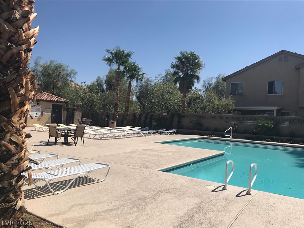646 Monument Point Street Henderson, NV 89002 - Photo 33 of 44 An inviting outdoor community pool and spa area with plentiful lounging space, perfect for a sunny afternoon. escape.