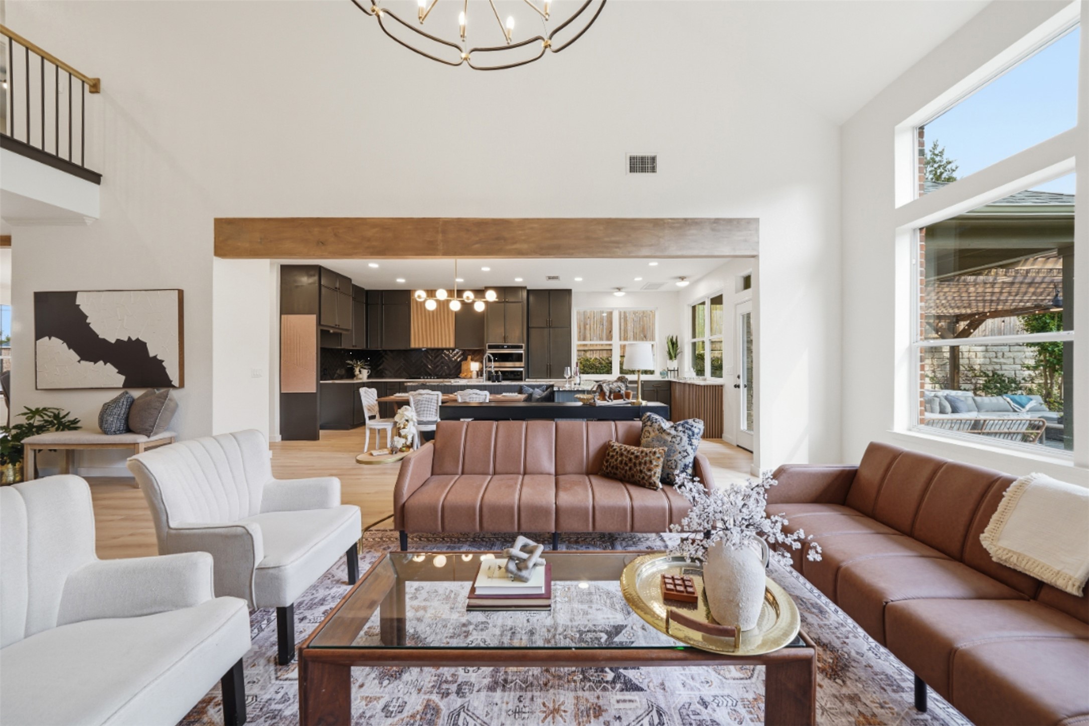 295 Desert Willow Way Austin, TX 78737 - Photo 1 of 1 Living area featuring a chandelier, light wood-style flooring, and a high ceiling